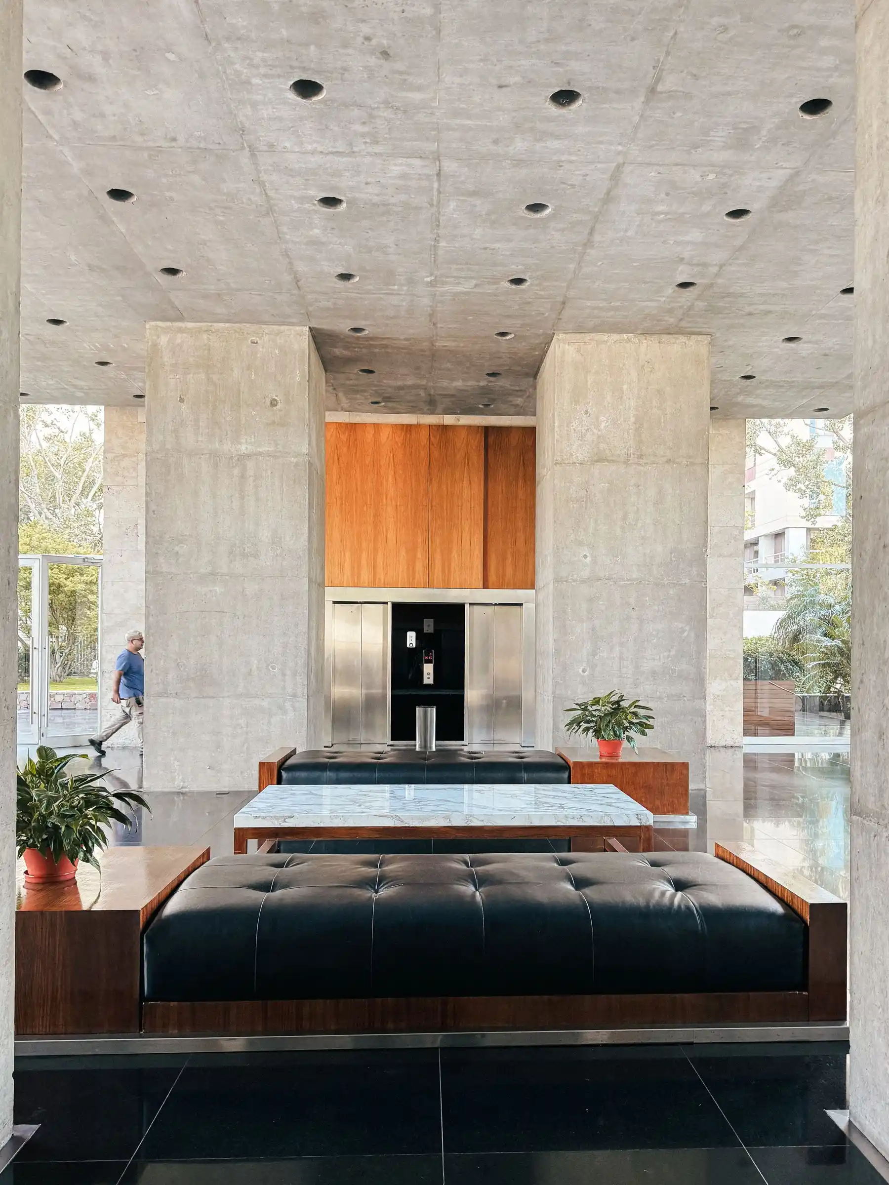 Building lobby with concrete columns and leather benches