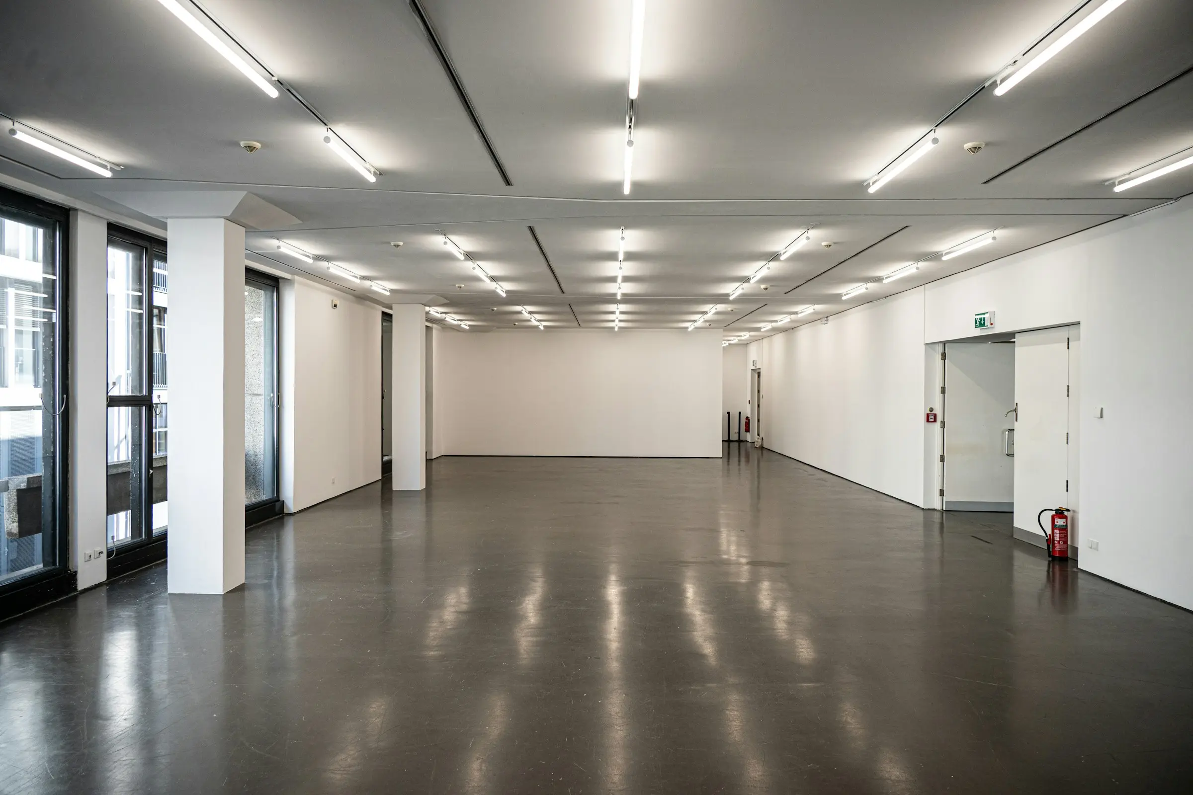 Empty room with white walls and a polished floor